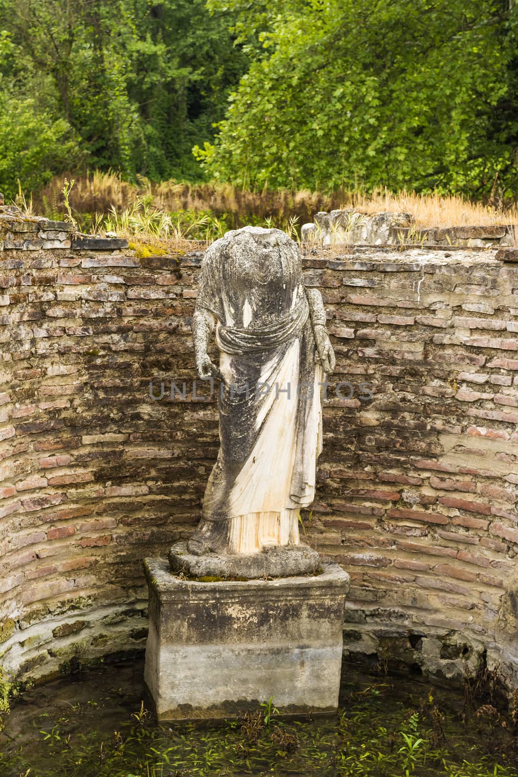 Ancient ruins and woman statue in the Dion Archeological Site in Greece