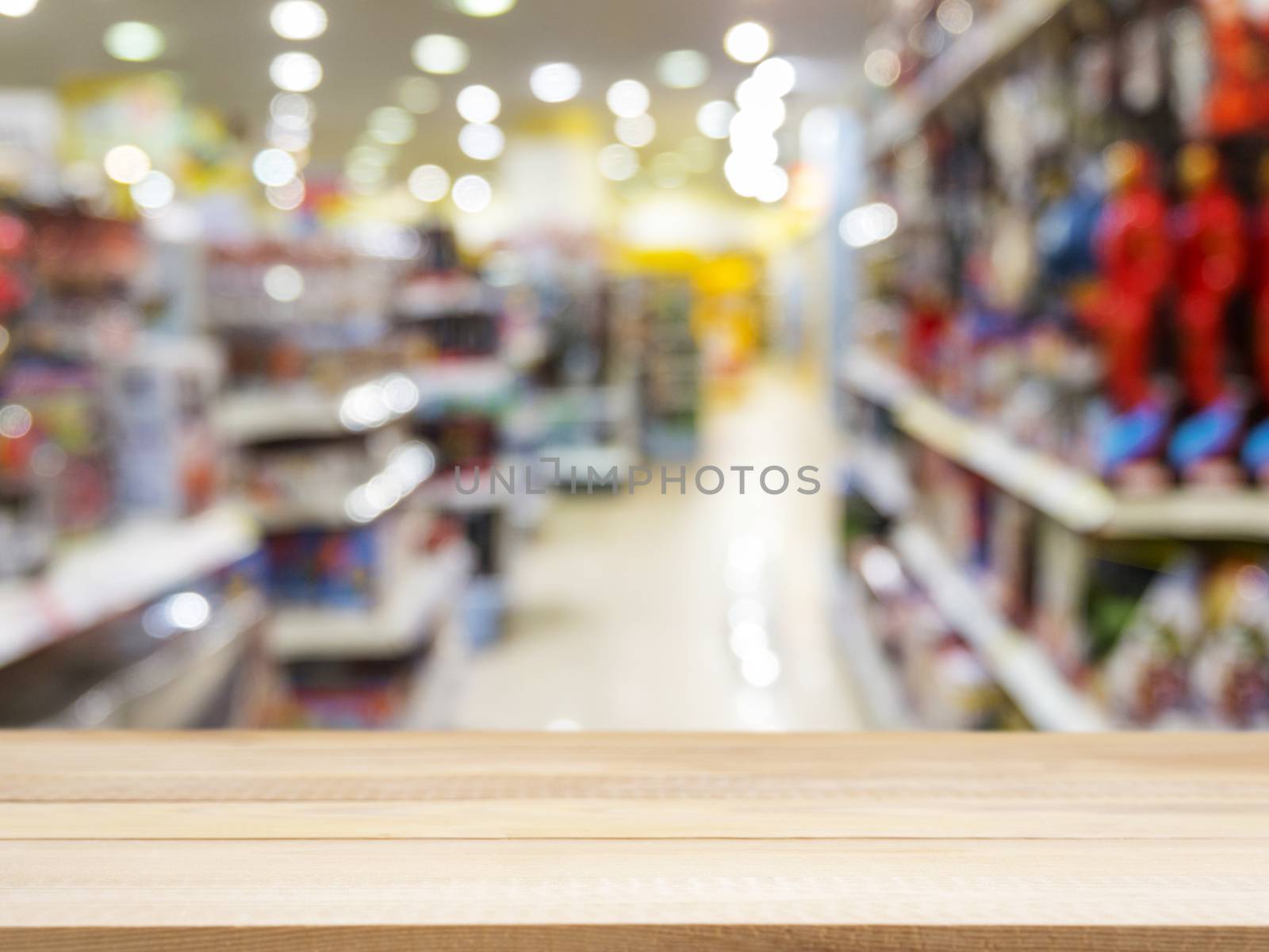 Wooden board empty table in front of blurred background. Perspective light wood over blur in kids toys store - can be used for display or montage your products. Mock up for display of product.