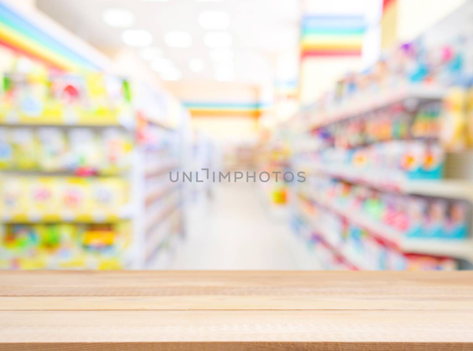 Wooden board empty table in front of blurred background. Perspective light wood over blur in kids toys store - can be used for display or montage your products. Mock up for display of product.
