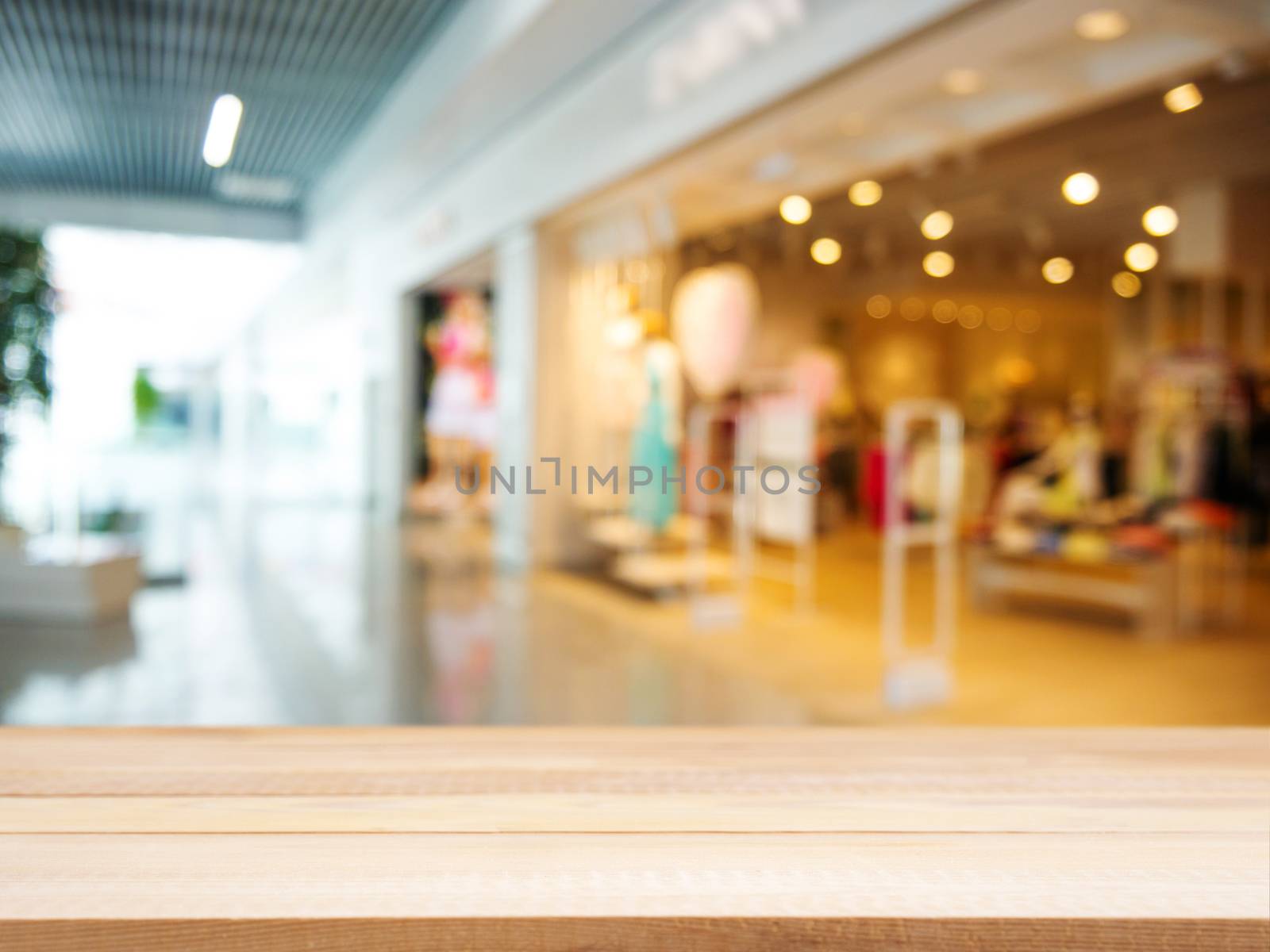 Wooden board empty table in front of blurred background. Perspective light wood over blur in shopping store - can be used for display or montage your products. Mock up for display of product.