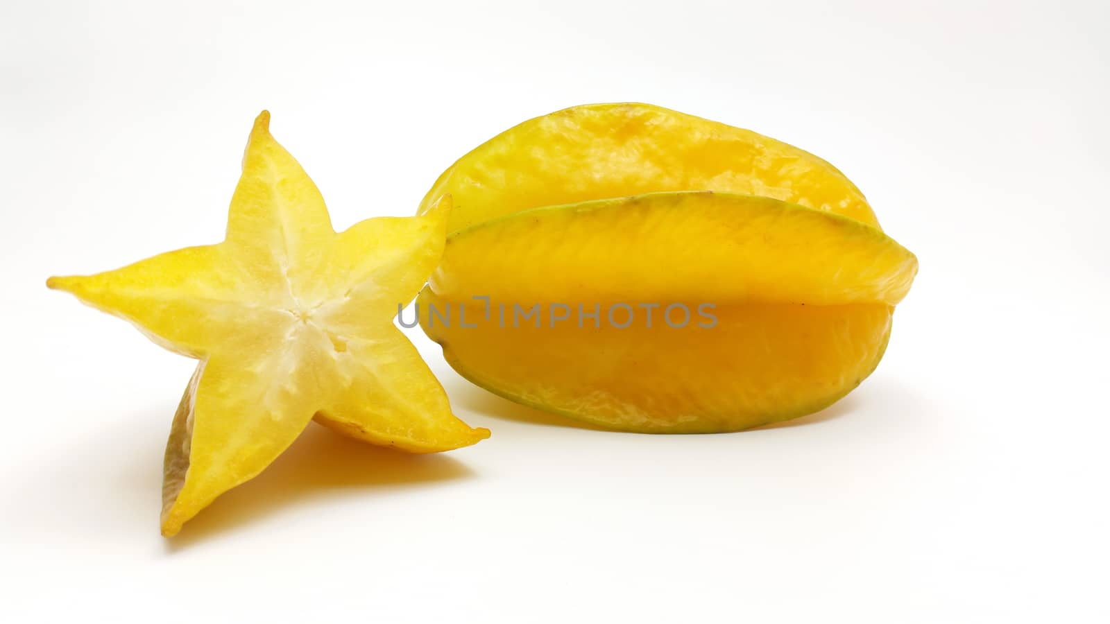 carambola - star fruit with slices on white background