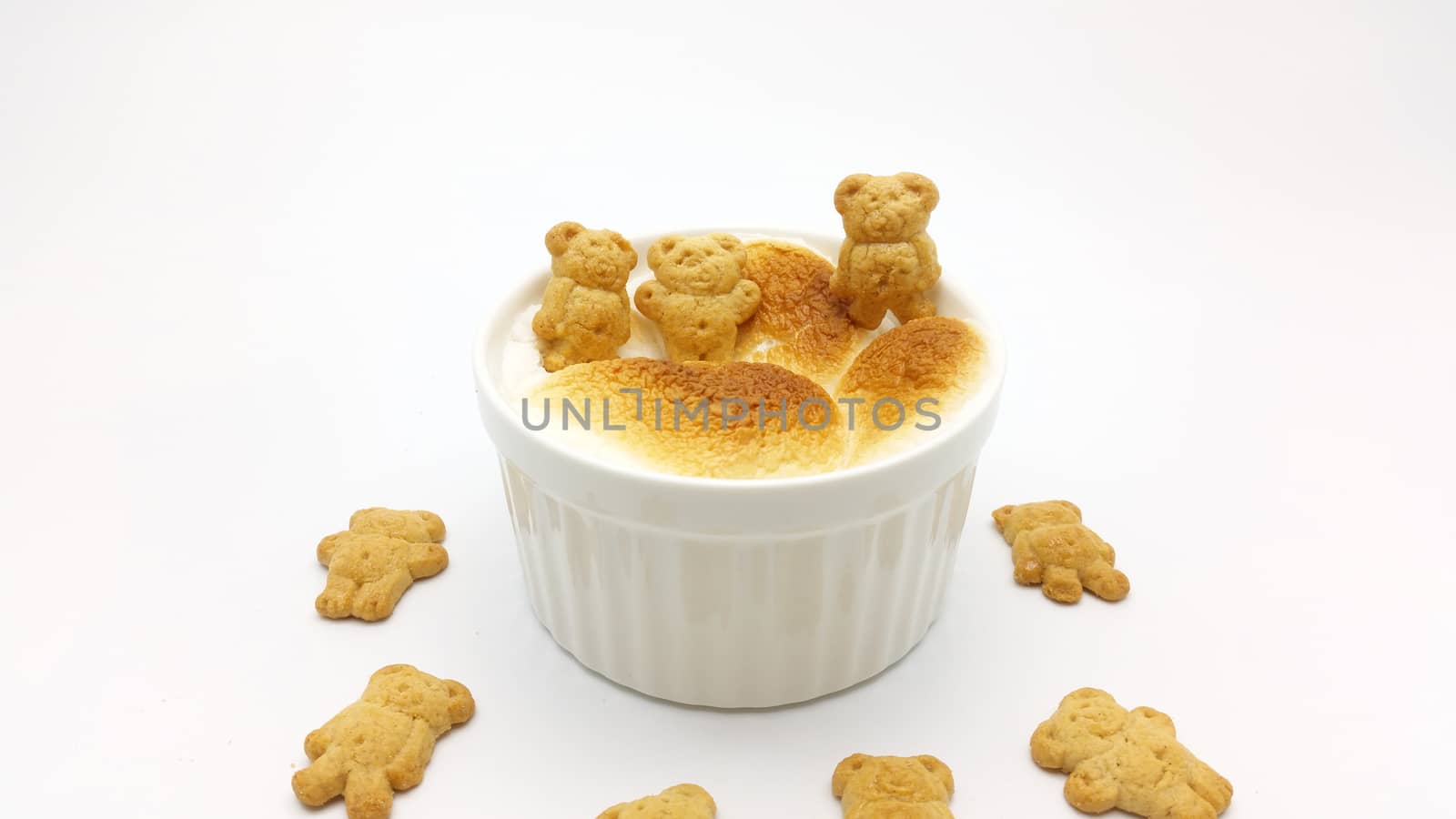 S'More dip with bear shape cookies on white background