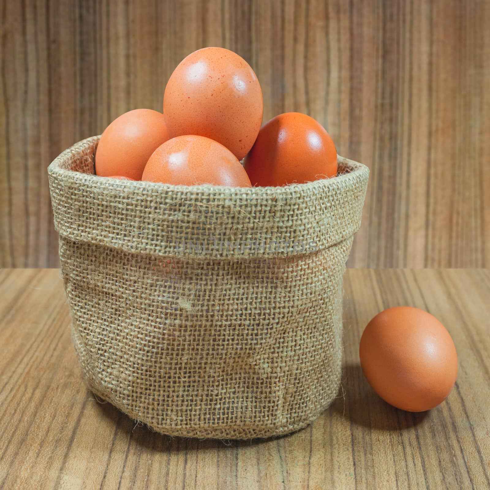 Eggs in basket on wood.eggs.egg.brown.rawfood by nopparats