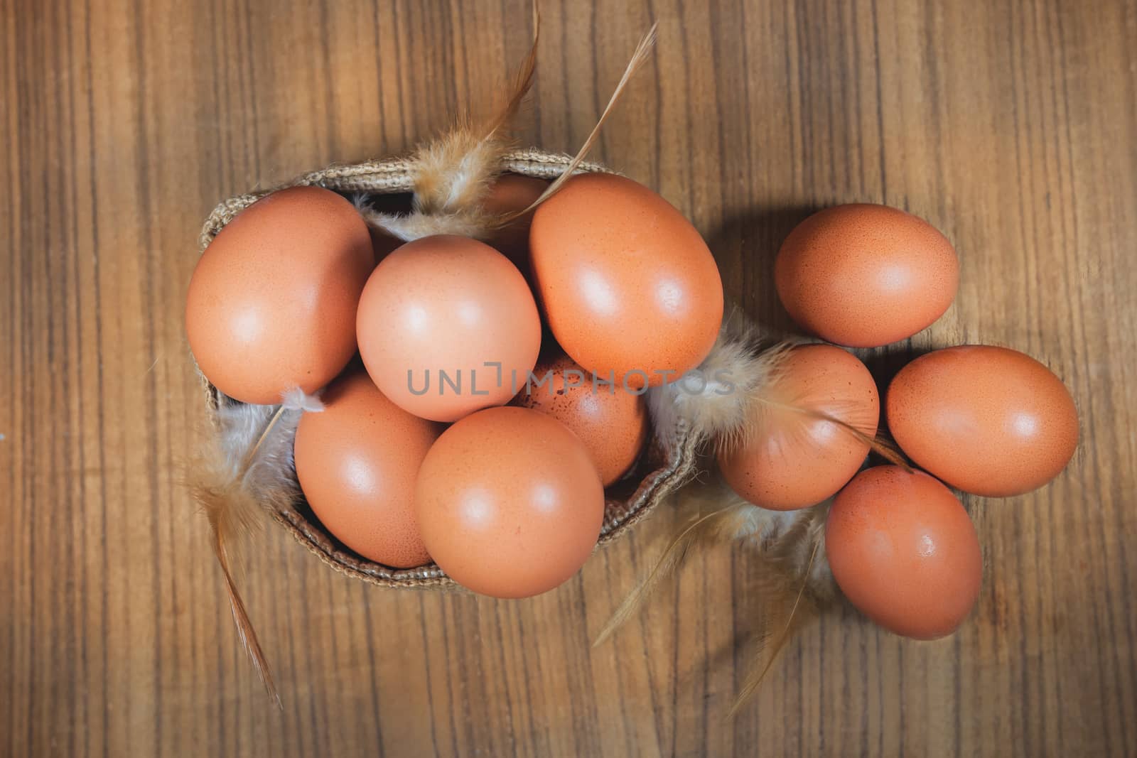 Eggs in basket on wood.eggs.egg.brown.rawfood by nopparats