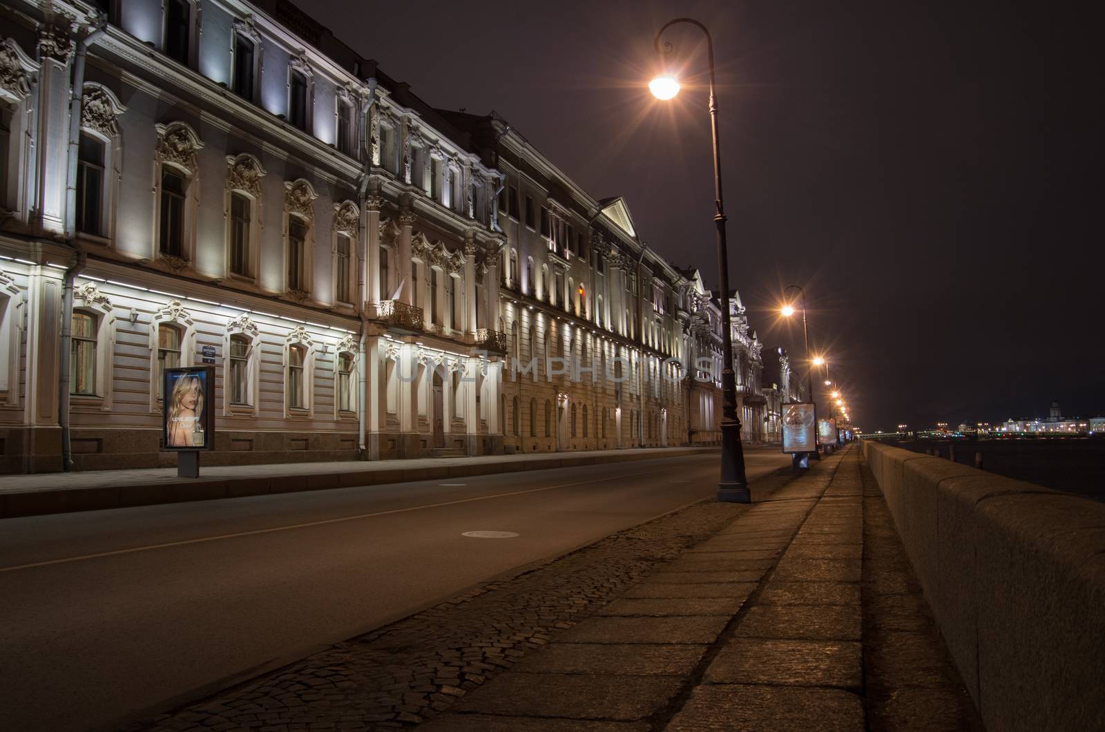 Night view of the granite Palace Embankment in St. Petersburg from Kamenoostrovsky bridge. House AP Gagarin architect Quarenghi D. cobblestone road and night lights