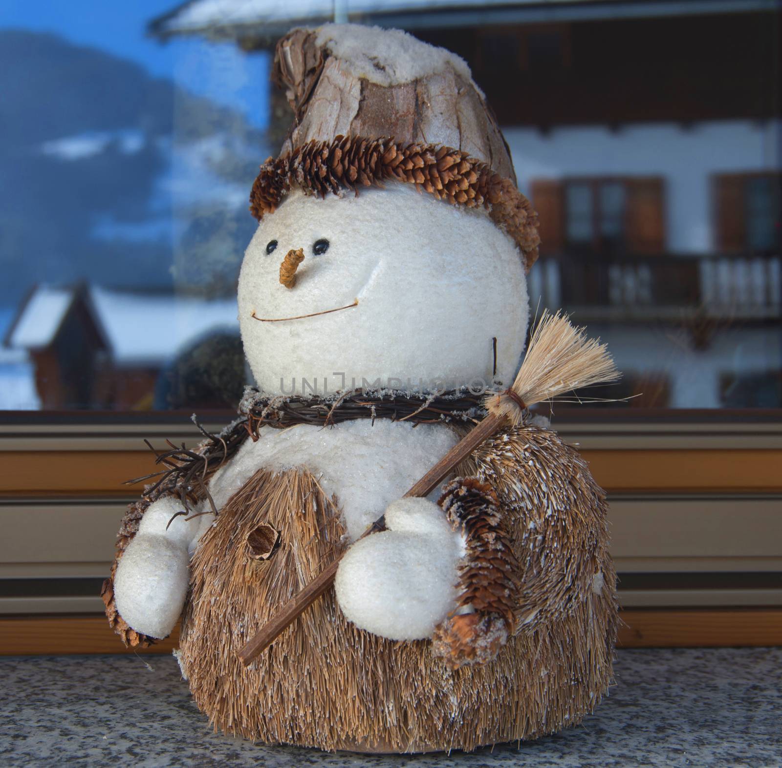 cheerful snowman in a white hat holding a broom snow