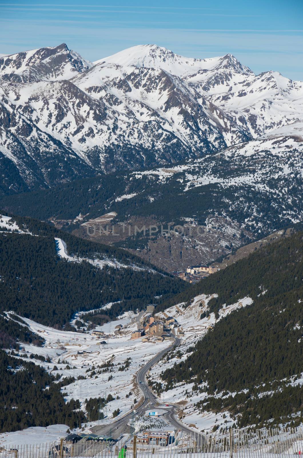 Skiing and snowboarding on the snowy slopes of prepared ski resort in Andorra