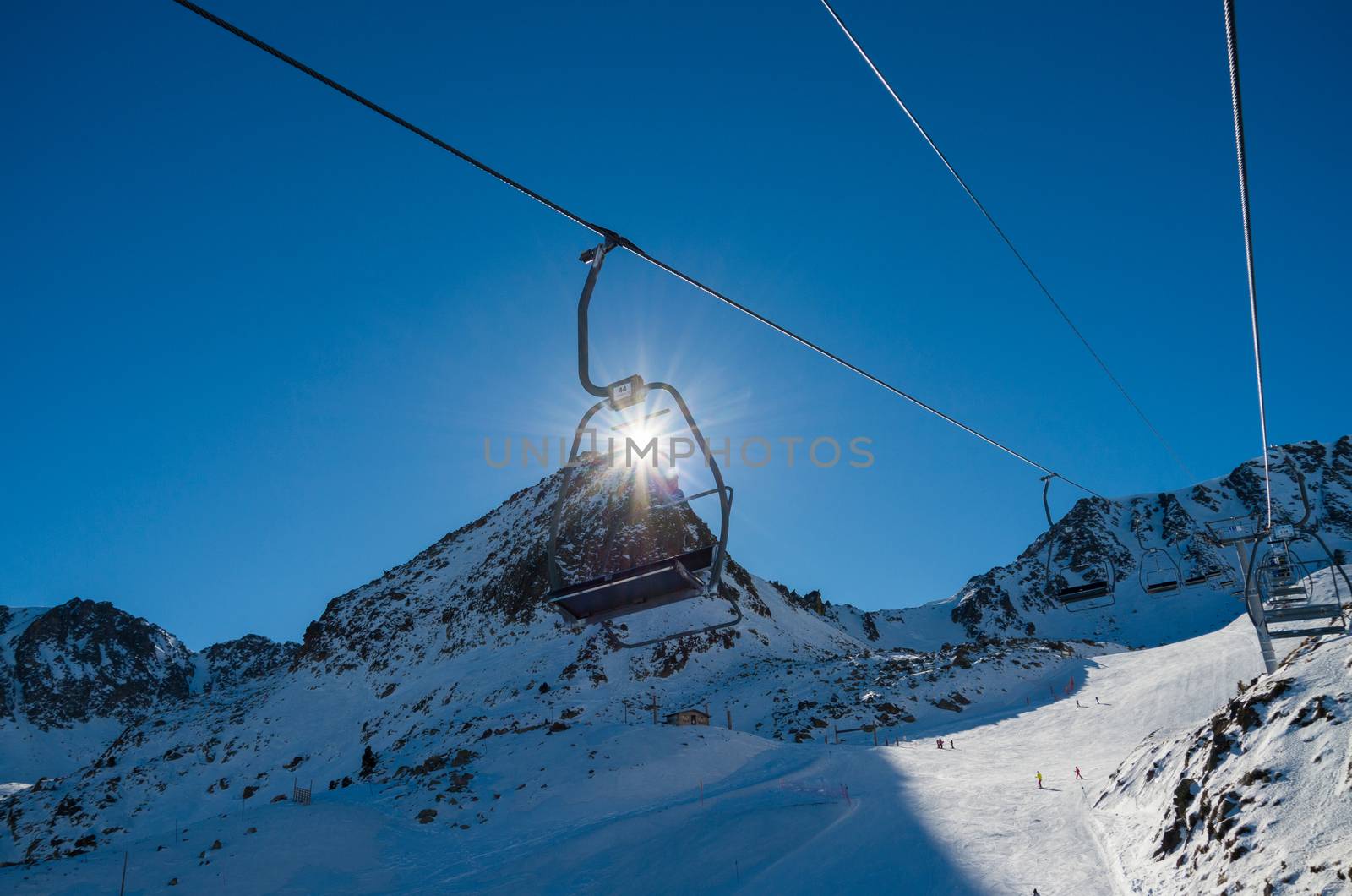 Skiing and snowboarding on the snowy slopes of prepared ski resort in Andorra