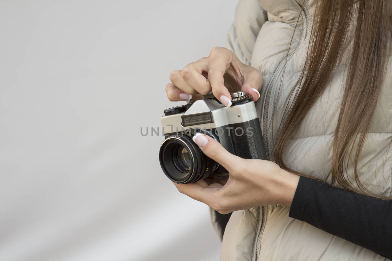the girl in the hands of is holding the vintage camera