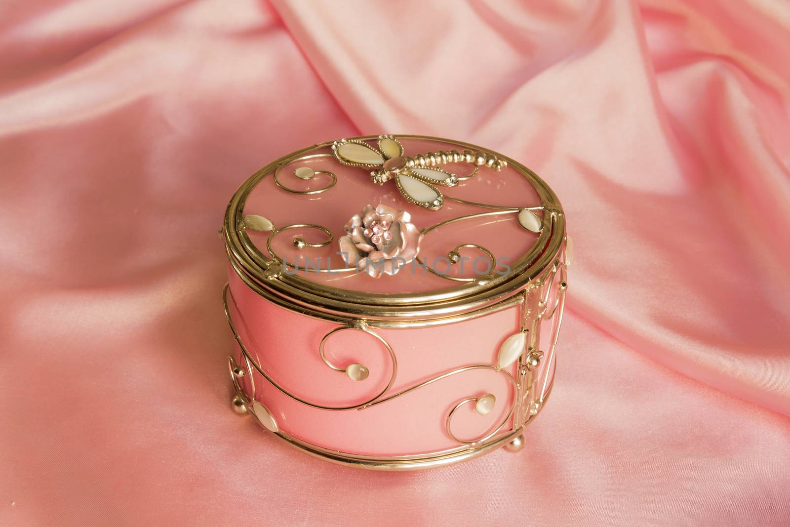 round decorative casket on a brilliant pink silk