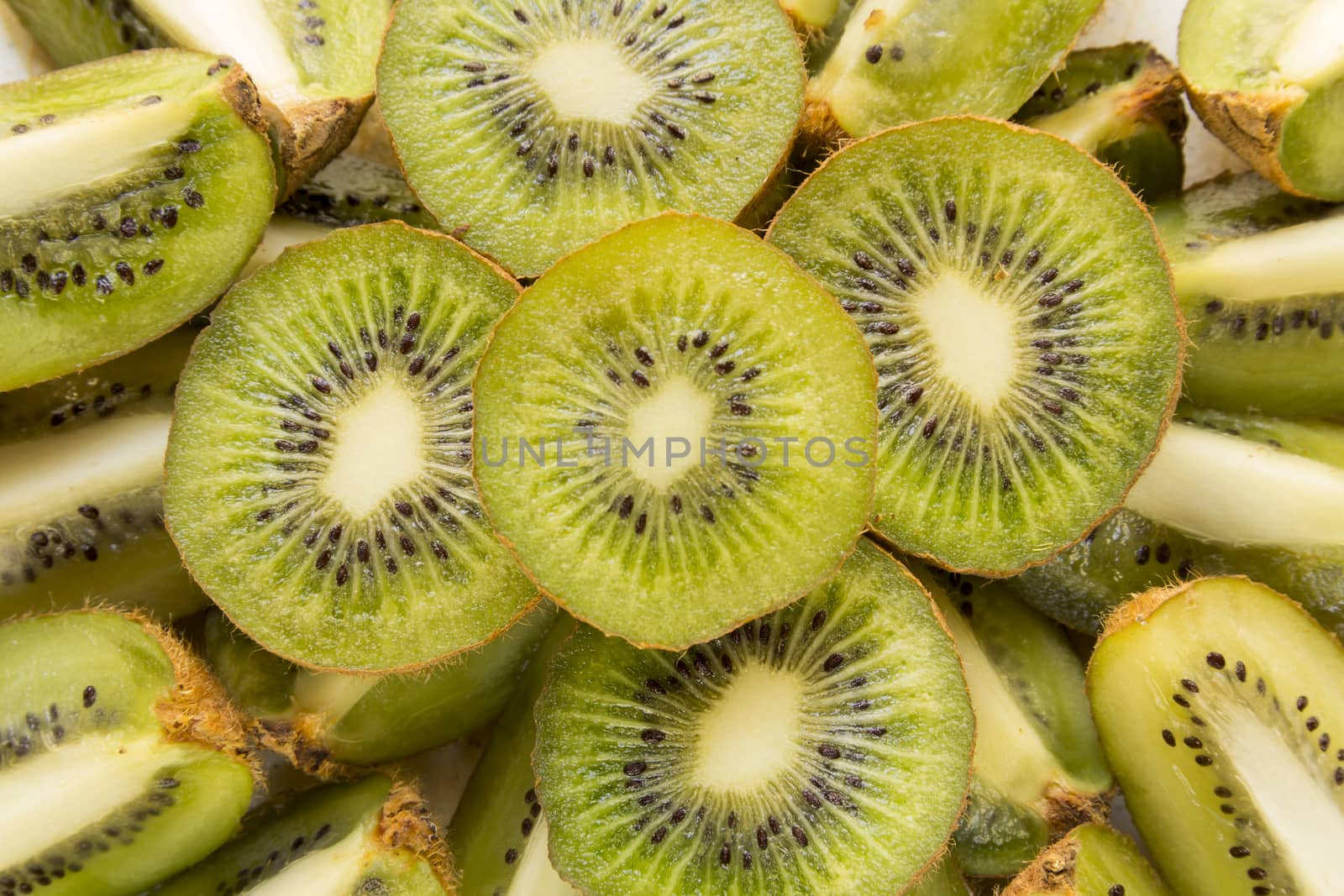 Fresh organic Kiwi Fruit Slices arranged showing the pips & structure