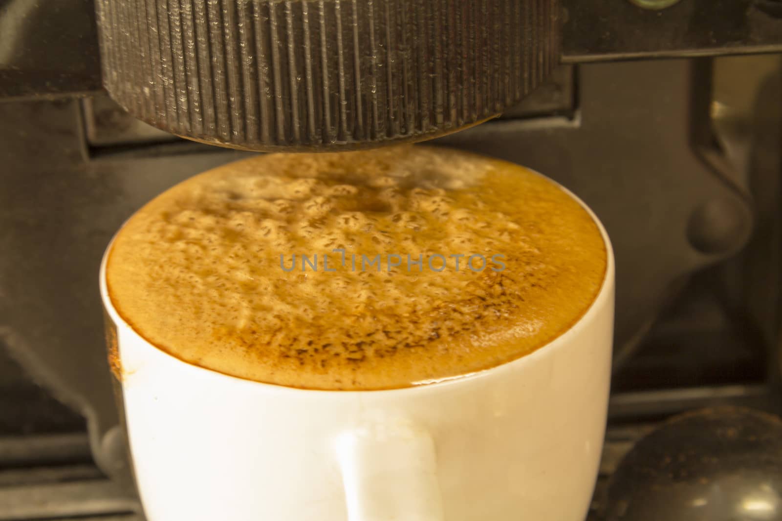 Black coffee in a white circle in the machine at home.