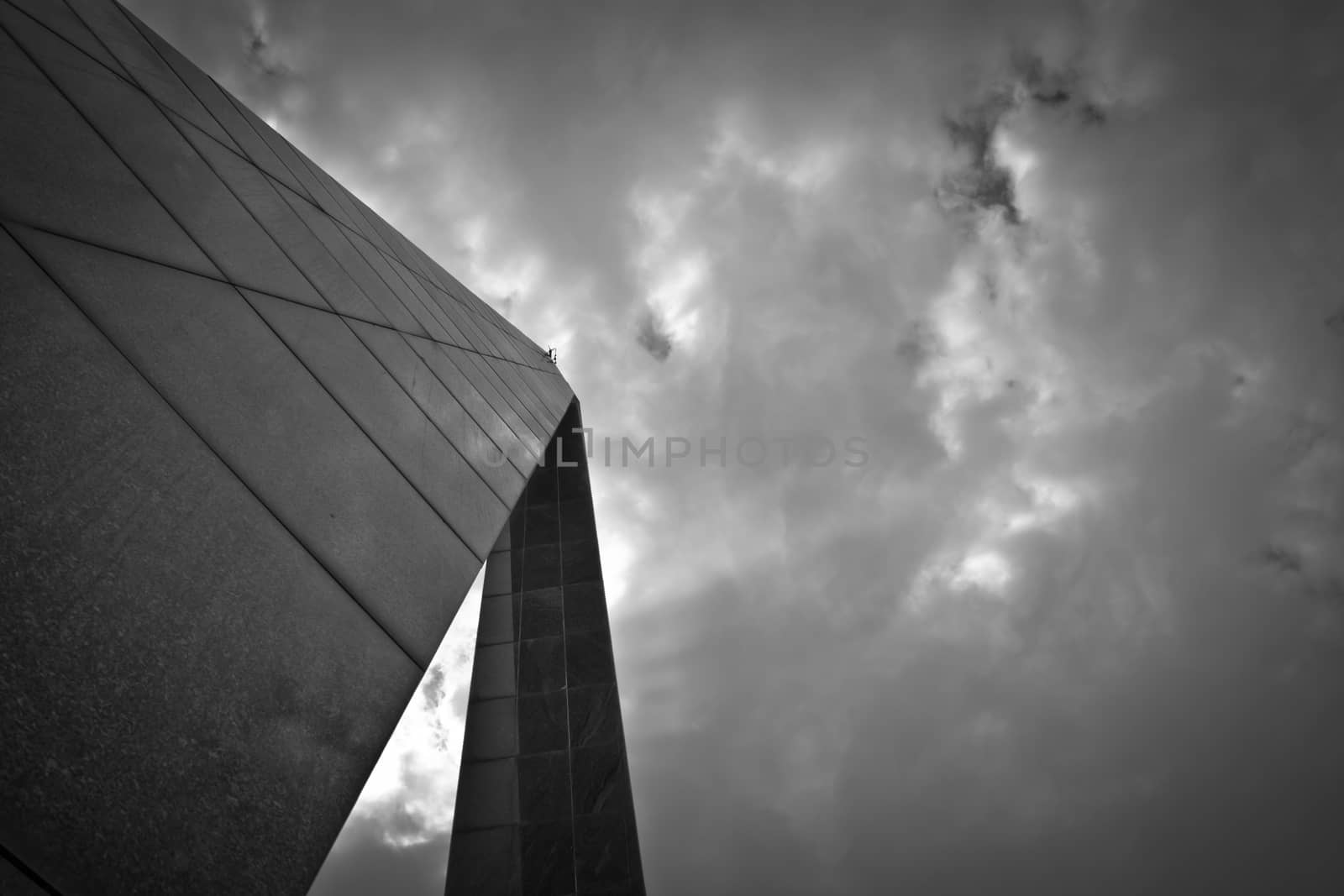 Black and white monument against cloudy sky low angle view