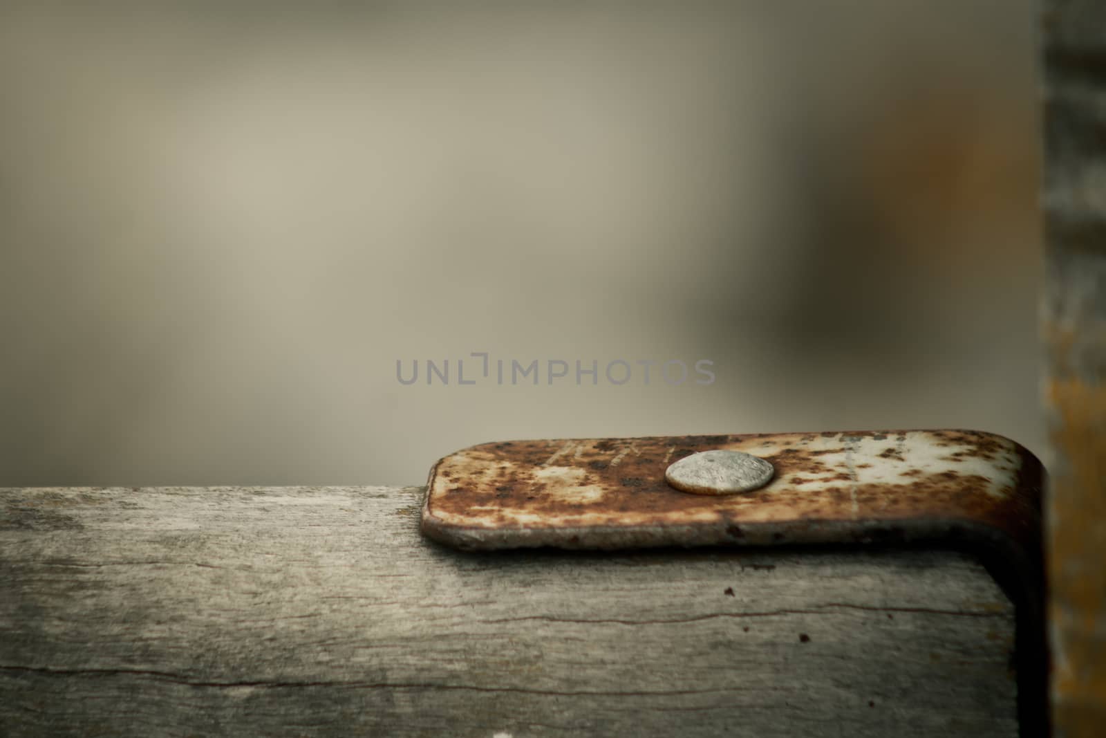 Close up of rusty bracer of wooden fence blurred backgrounds