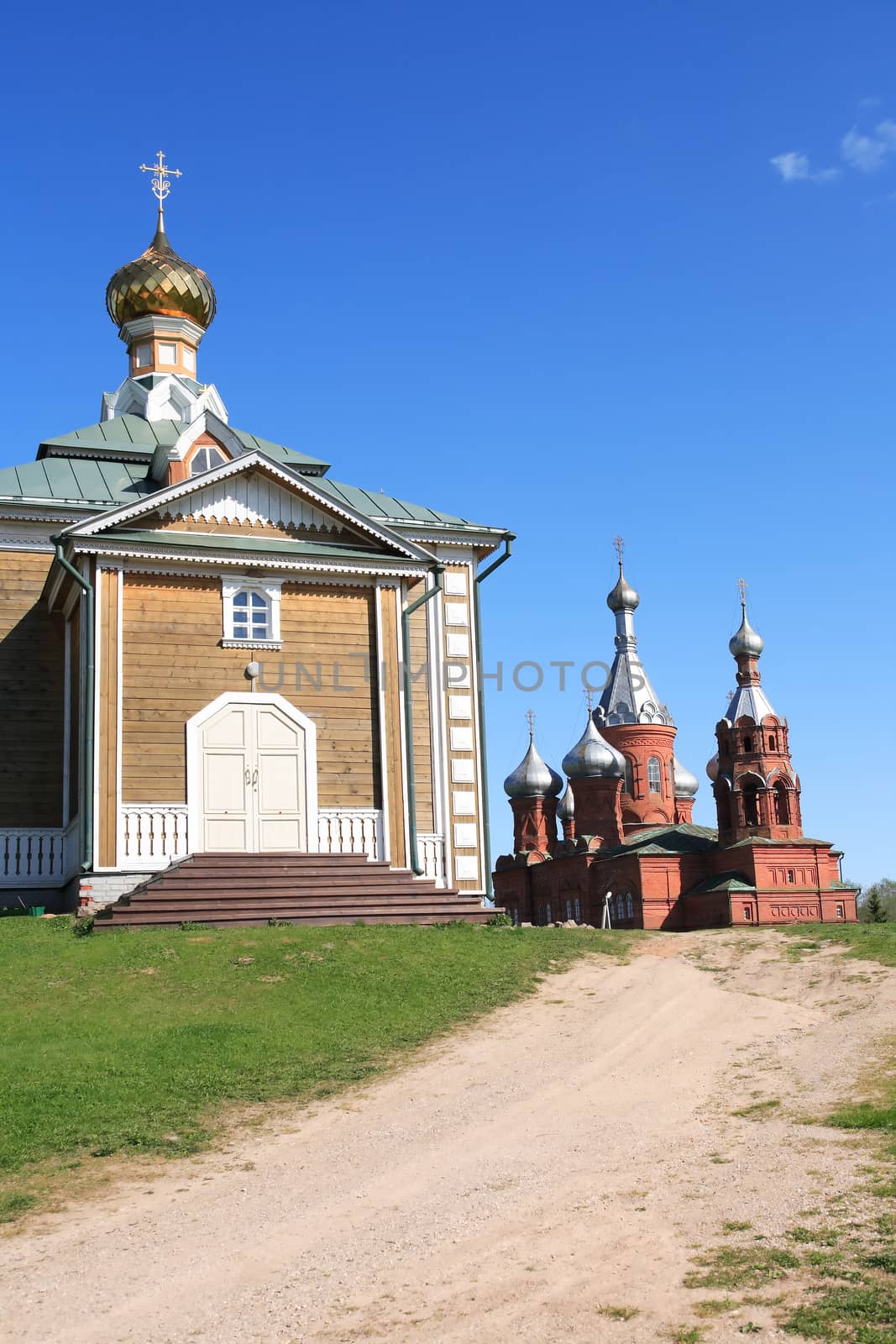 Old Russian abbey against blue sky at summer