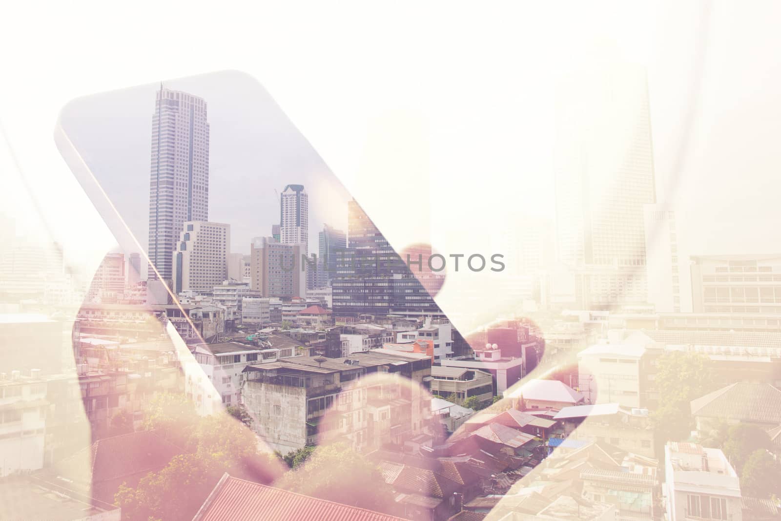 Double exposure image of businessman sitting in the airplane and using smart phone with cityscape background, Business technology concept.