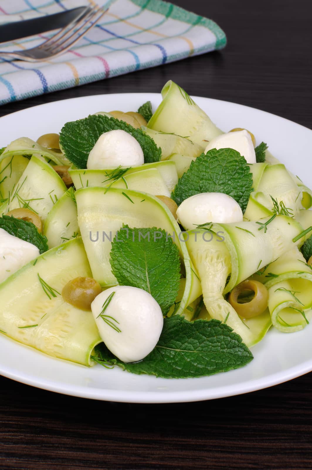 Zucchini salad with mozzarella, olives, dill and mint