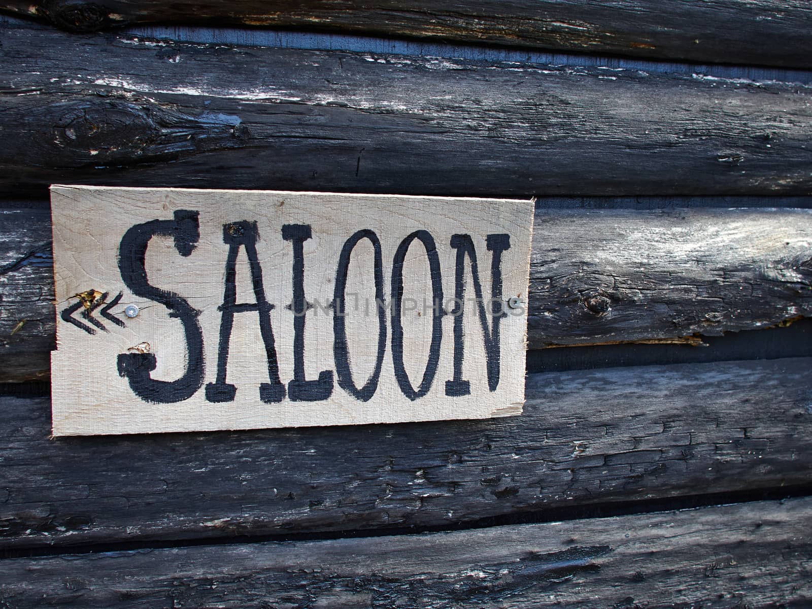 Wild west American saloon sign hanged on a wooden house   