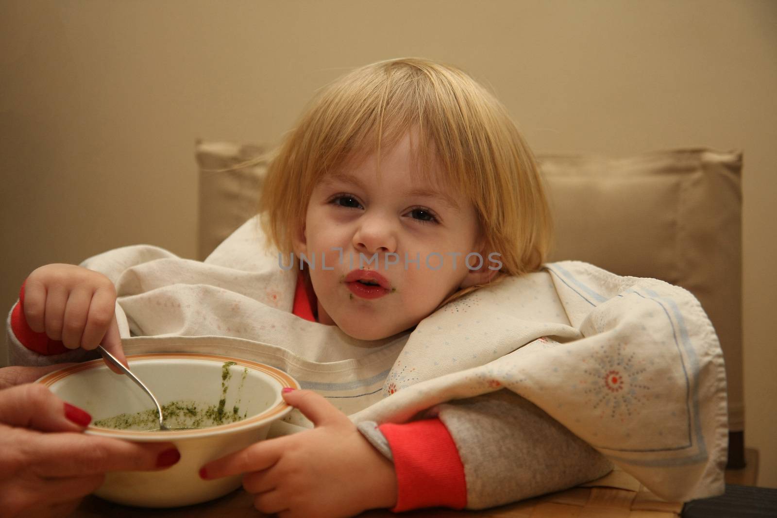 Young girl enjoys eating nettle chowder