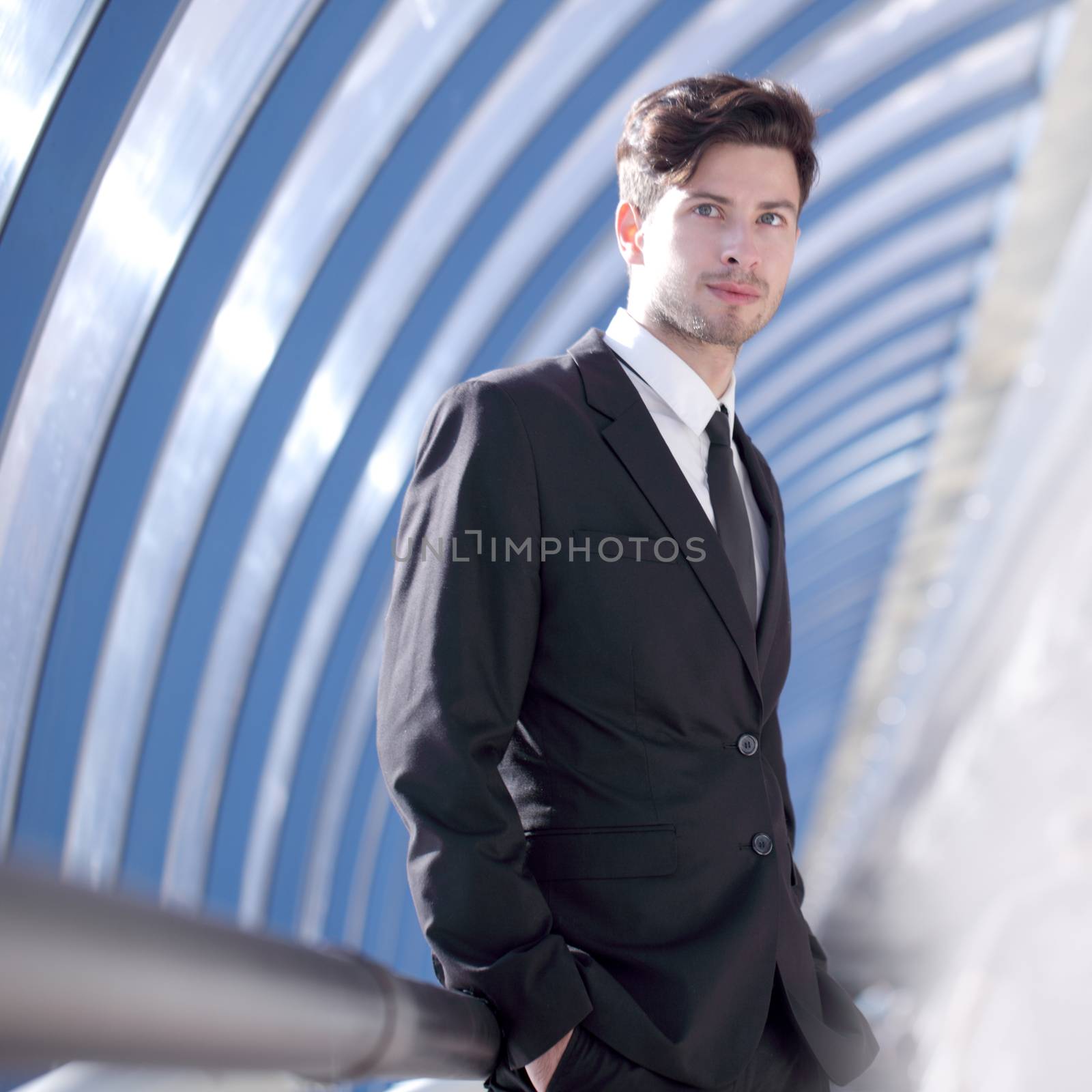 Young Businessman standing in corridor of modern office building