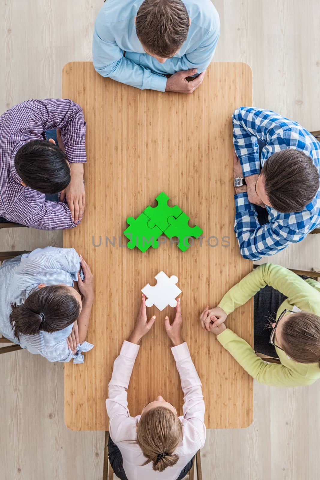 People assembling puzzle, corporate teamwork concept