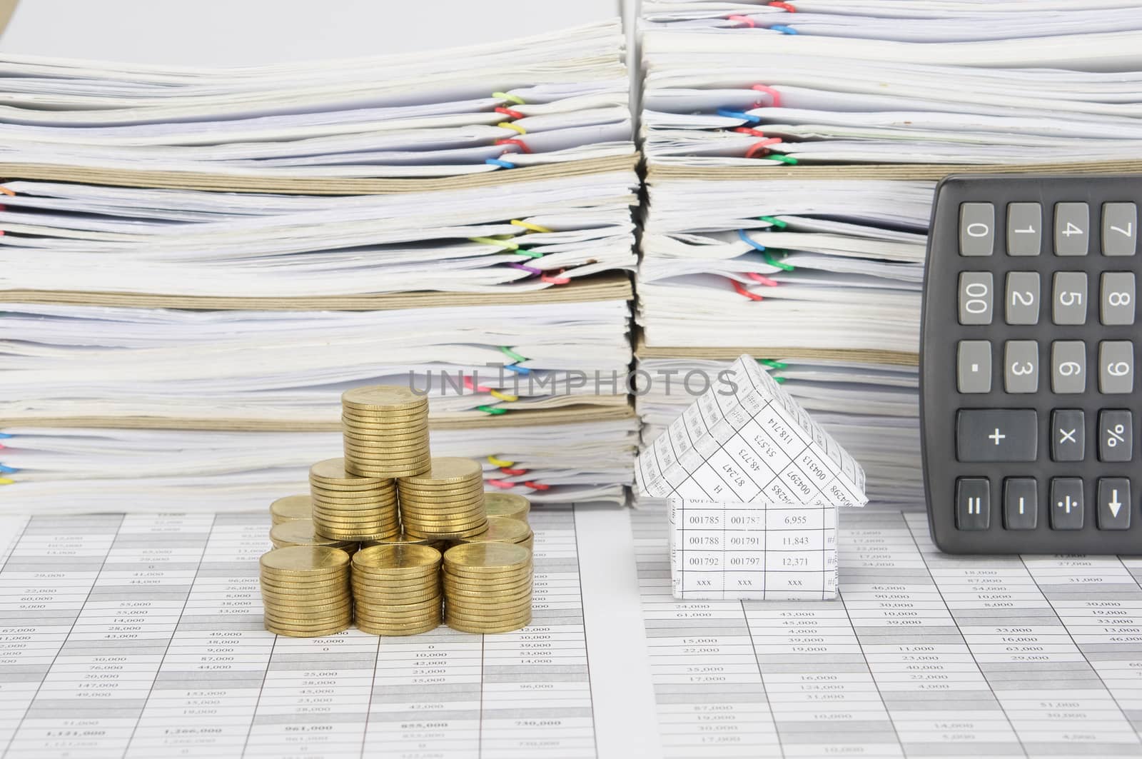 House and stack of gold coins as tower by eaglesky