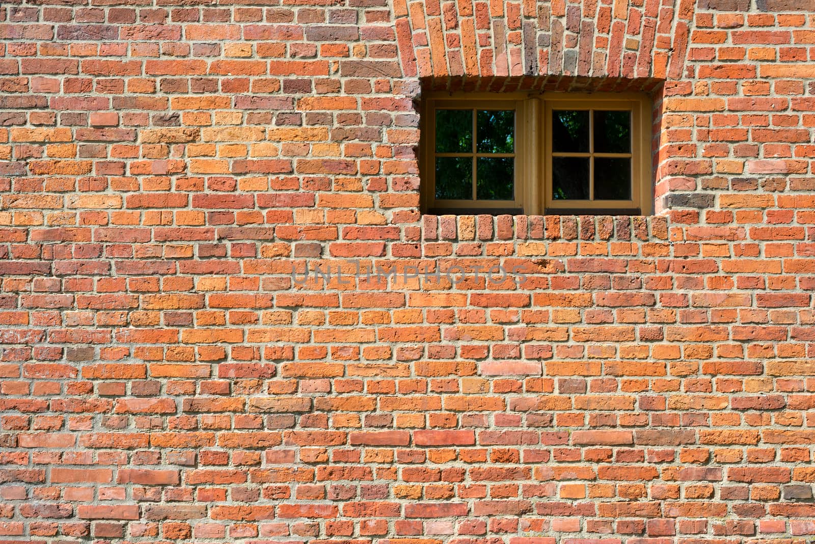Small modern plastic window on vintage old brick wall background. Glass isolated with patch