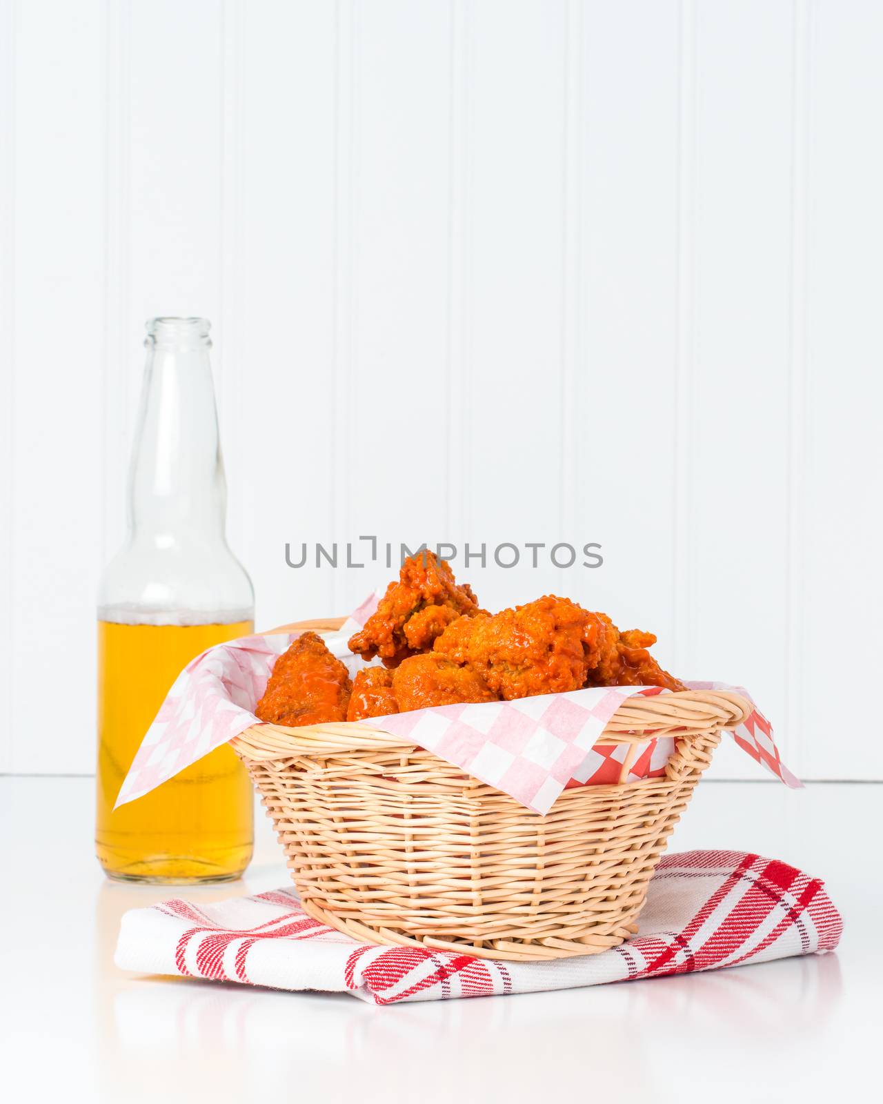 Wicker basket filled with buffalo style chicken wings.