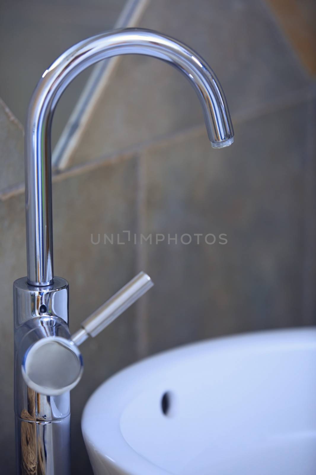 Water tap and sink in domestic bathroom