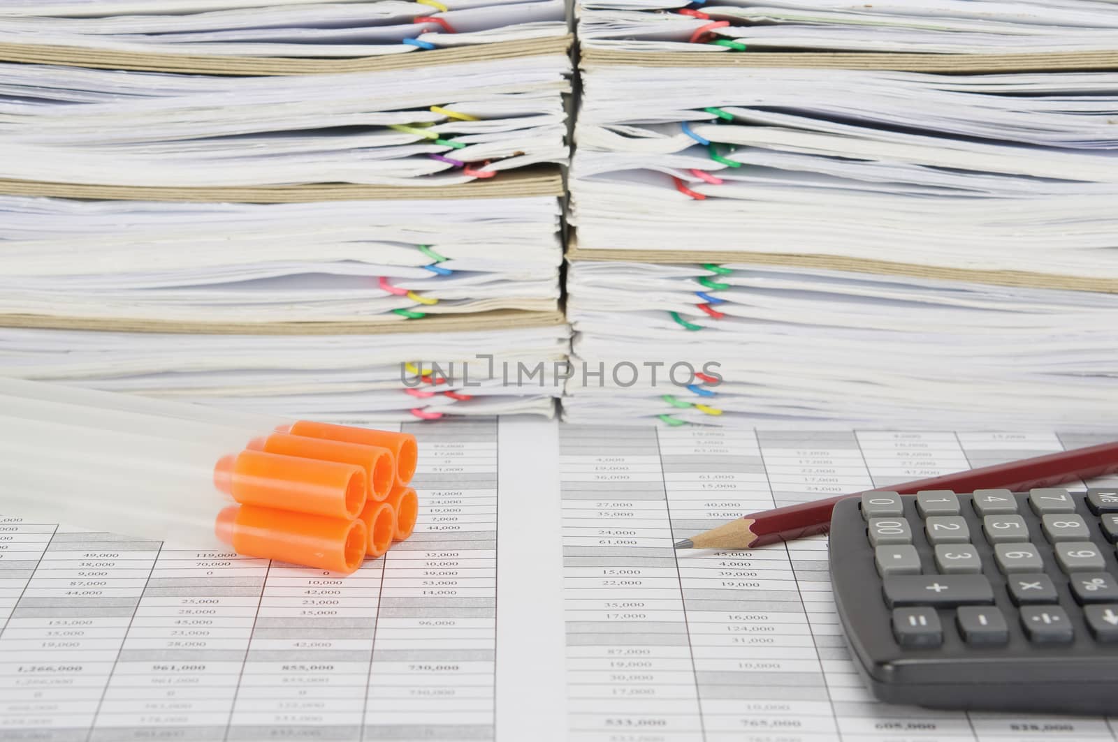 Specimen tube for laboratory test with orange cap with brown pencil and calculator on finance account have overload of paperwork with colorful paperclip and envelope as background.