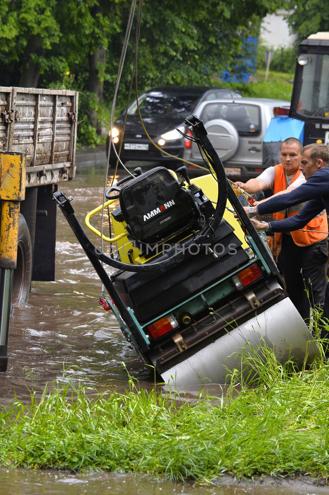 Car rides in heavy rain on a flooded road