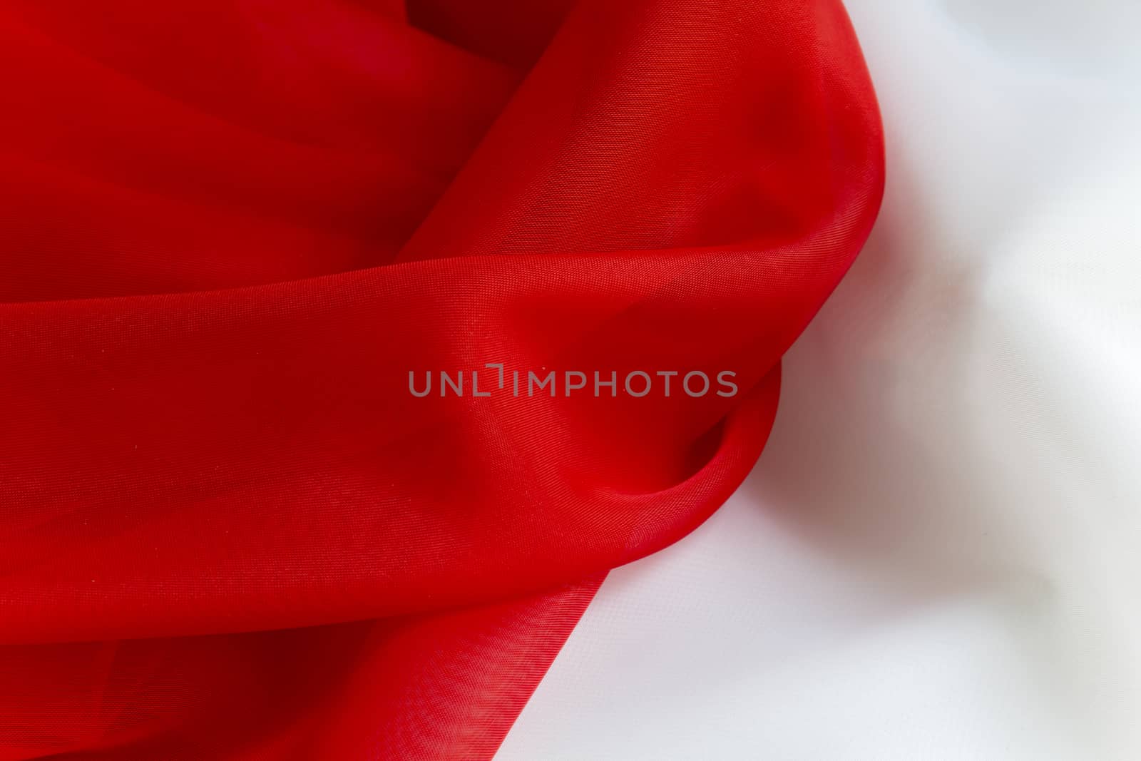 delicate Red on White silky fabric folds background texture