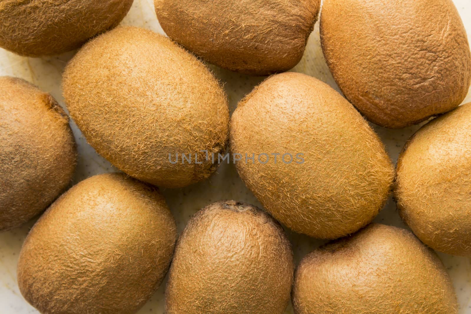 Exotic juicy, fresh Brown, hairy Kiwi fruit on a white background.