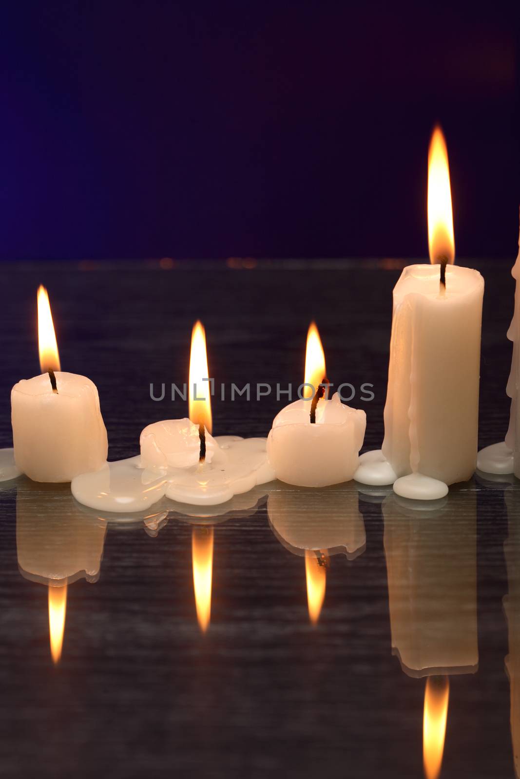 Set of lighting candles in a row on nice dark background