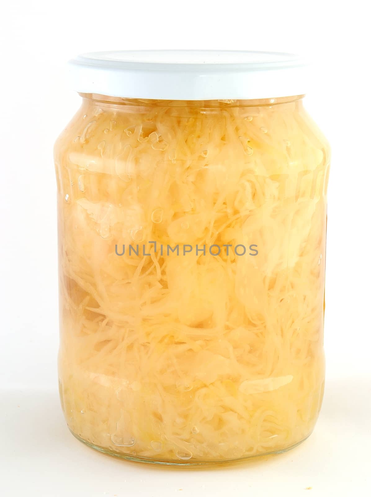 Cabbage jamed to the jar with white lid.