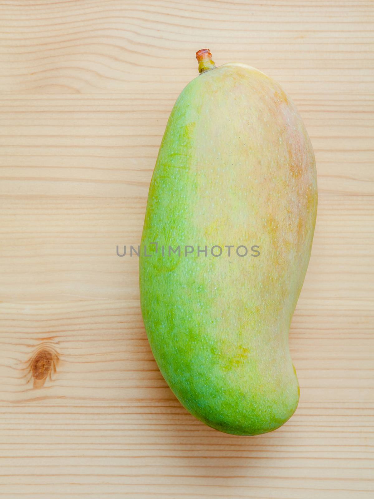 Fresh organic traditional thai mangoes high vitamins and minerals set up on wooden table.