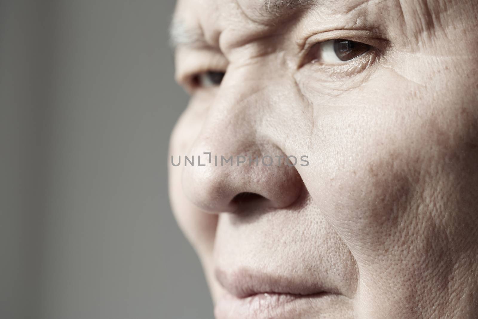 Face of elderly man looking at camera. Horizontal photo