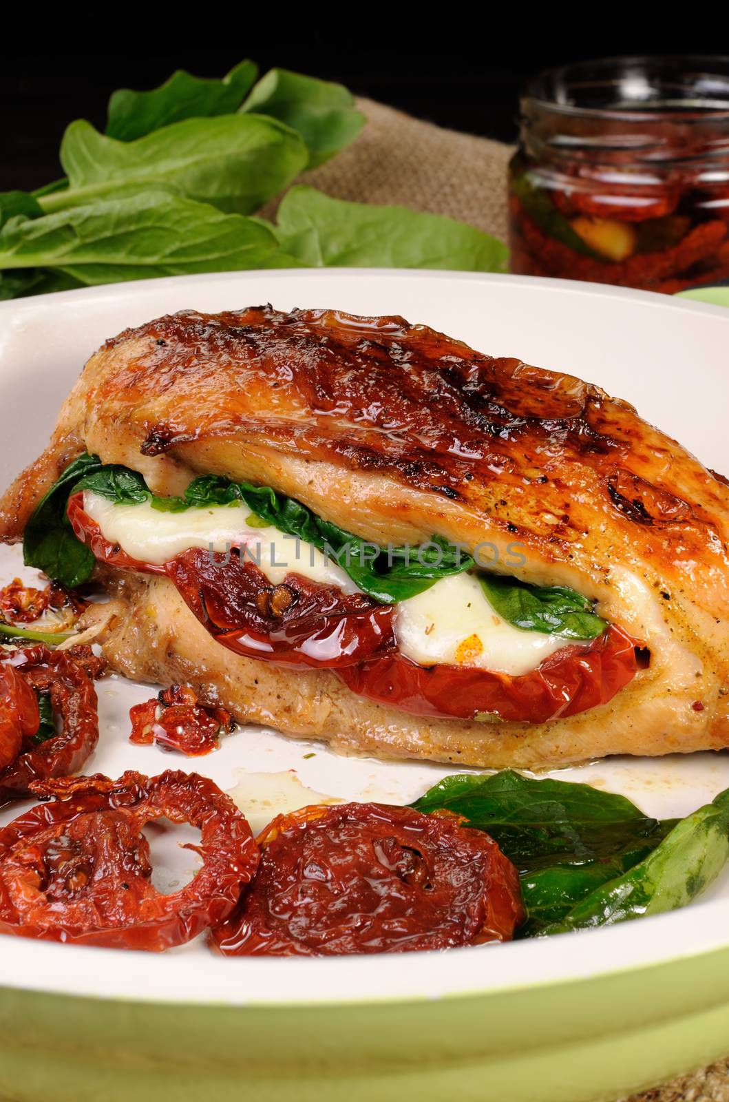 Baked chicken breast stuffed with mozzarella, spinach, sun-dried tomatoes