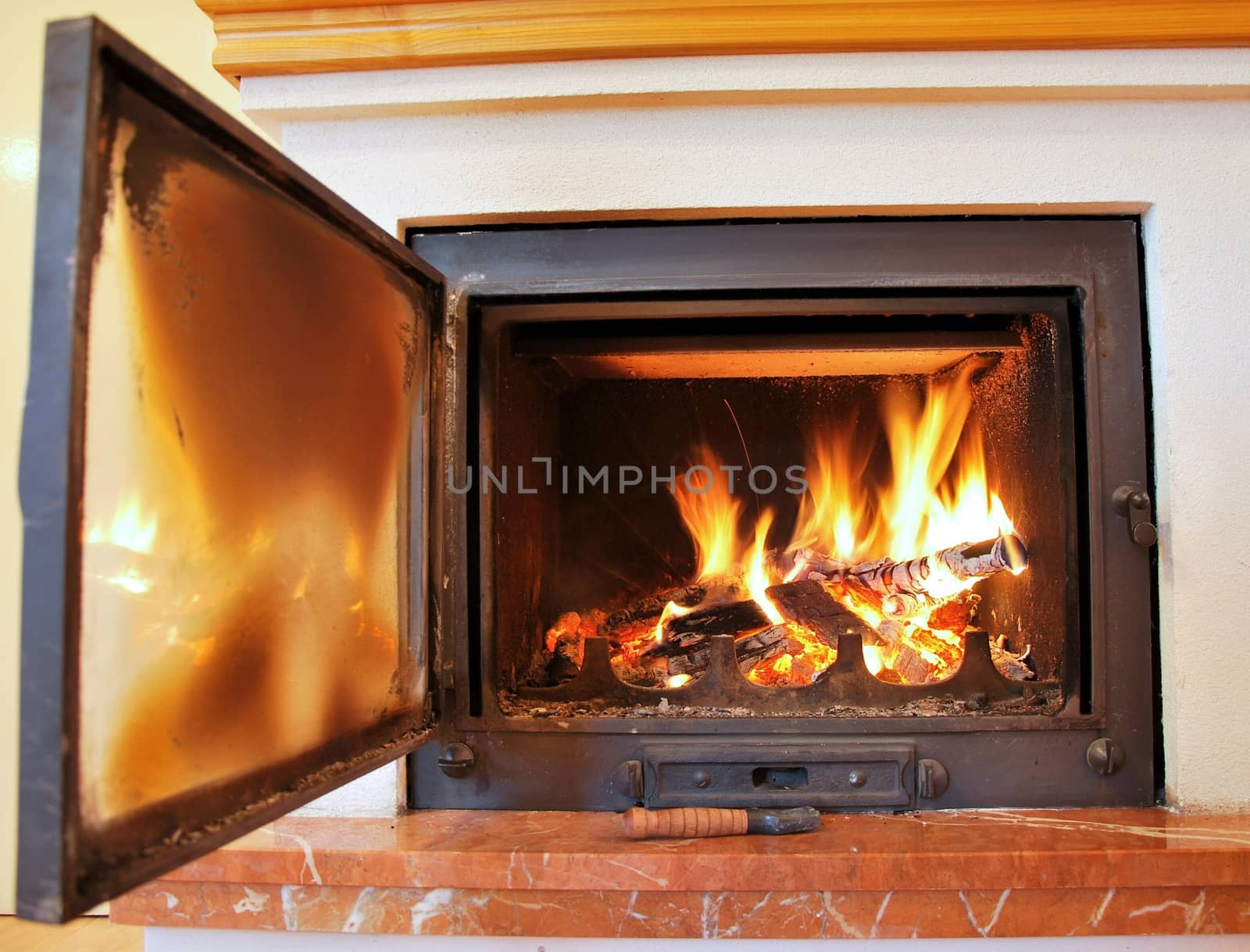 Indoor fireplace with open door.