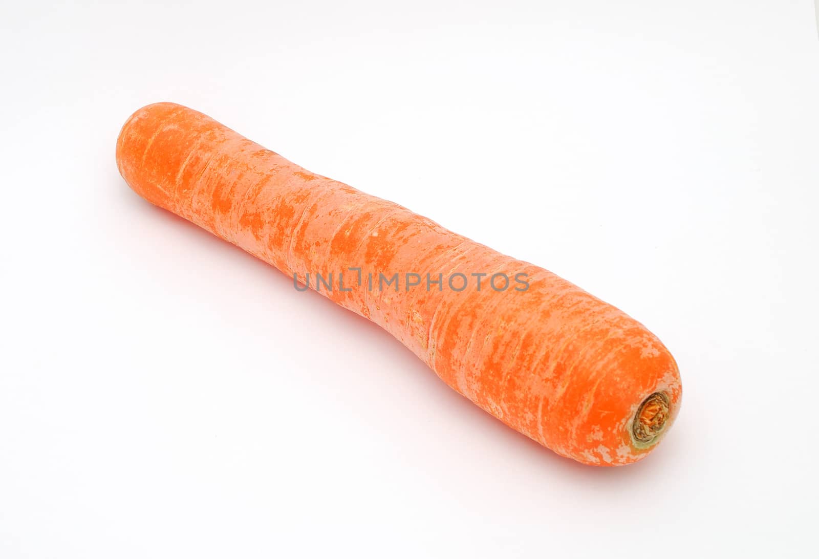 Detail image of one dirty carrot on the white background.