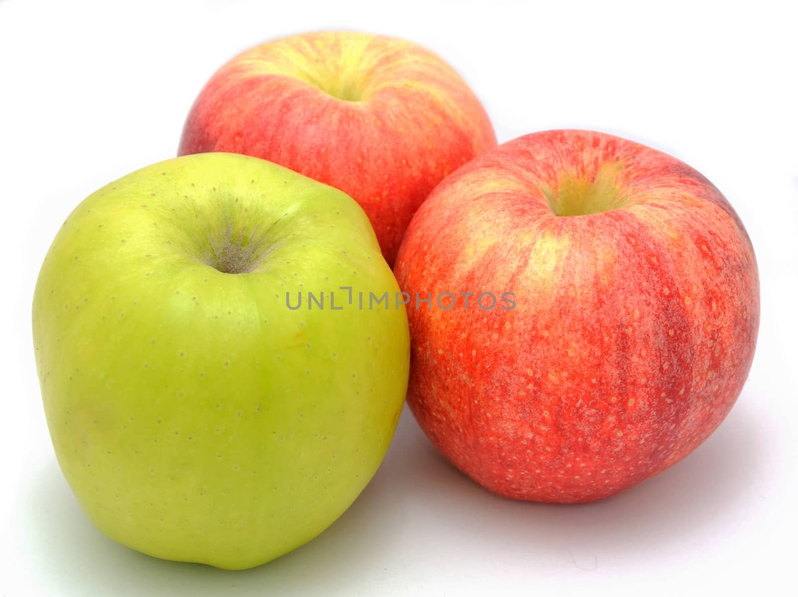 Red and green apples placed on the white background.