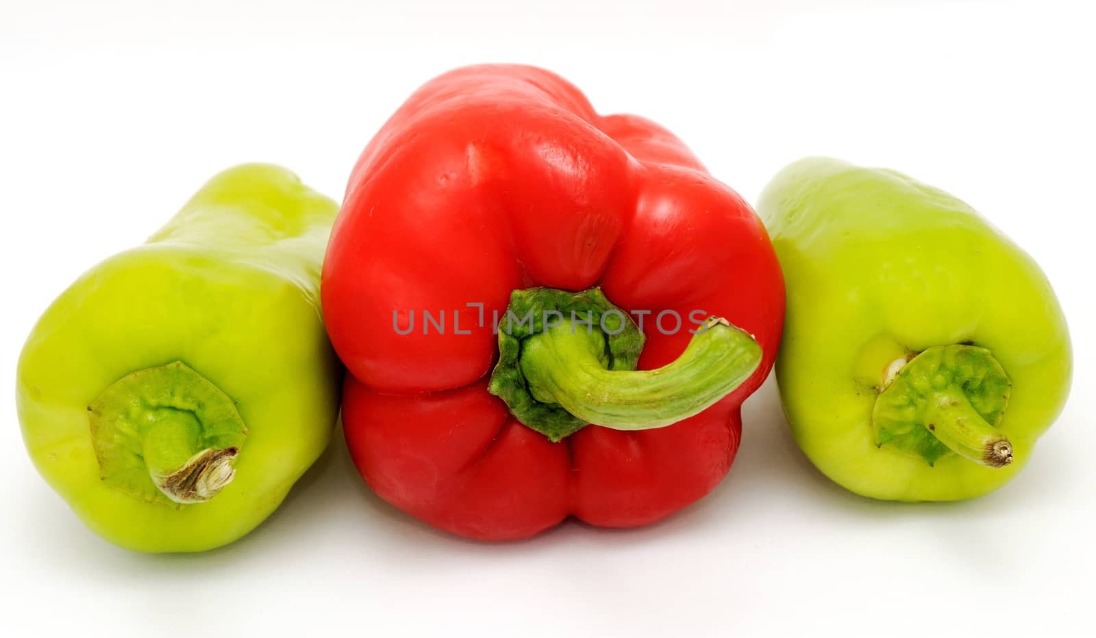 Red and green pepper placed on the white background.