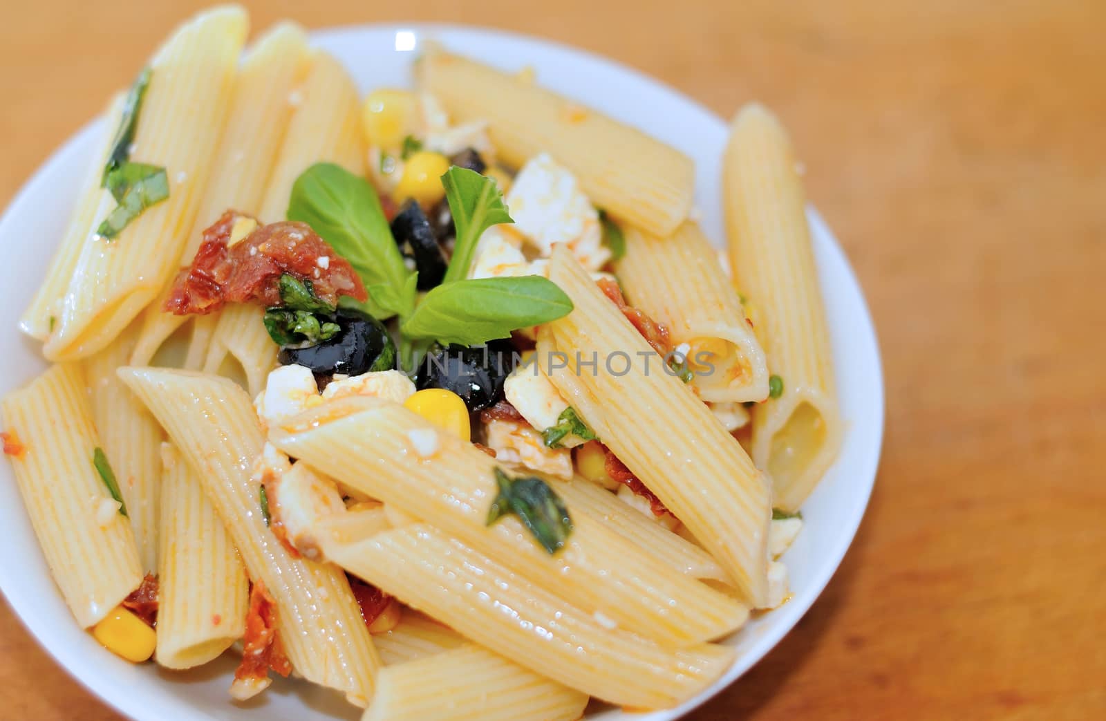 Pasta salad with olives and dry tomatoes.