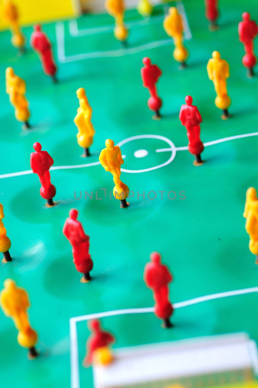 Macro shoot of red and yellow players of tabletop football game.