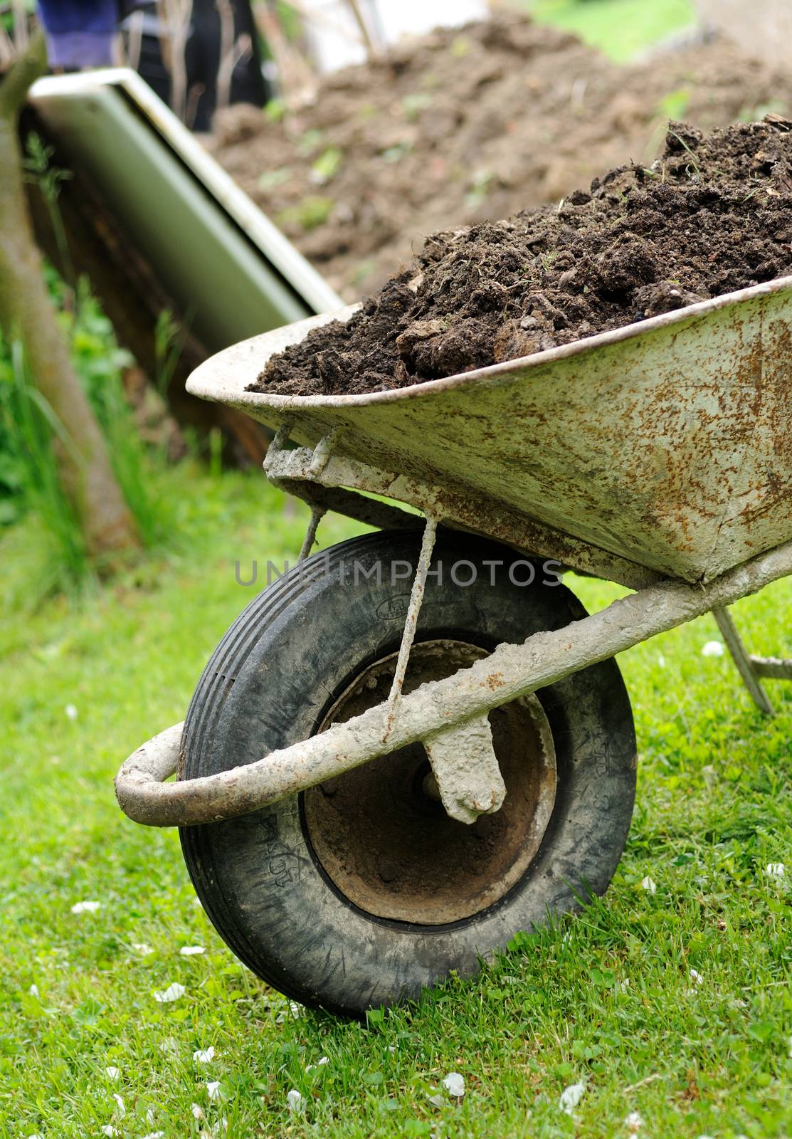 Hand barrow loaded by earth.