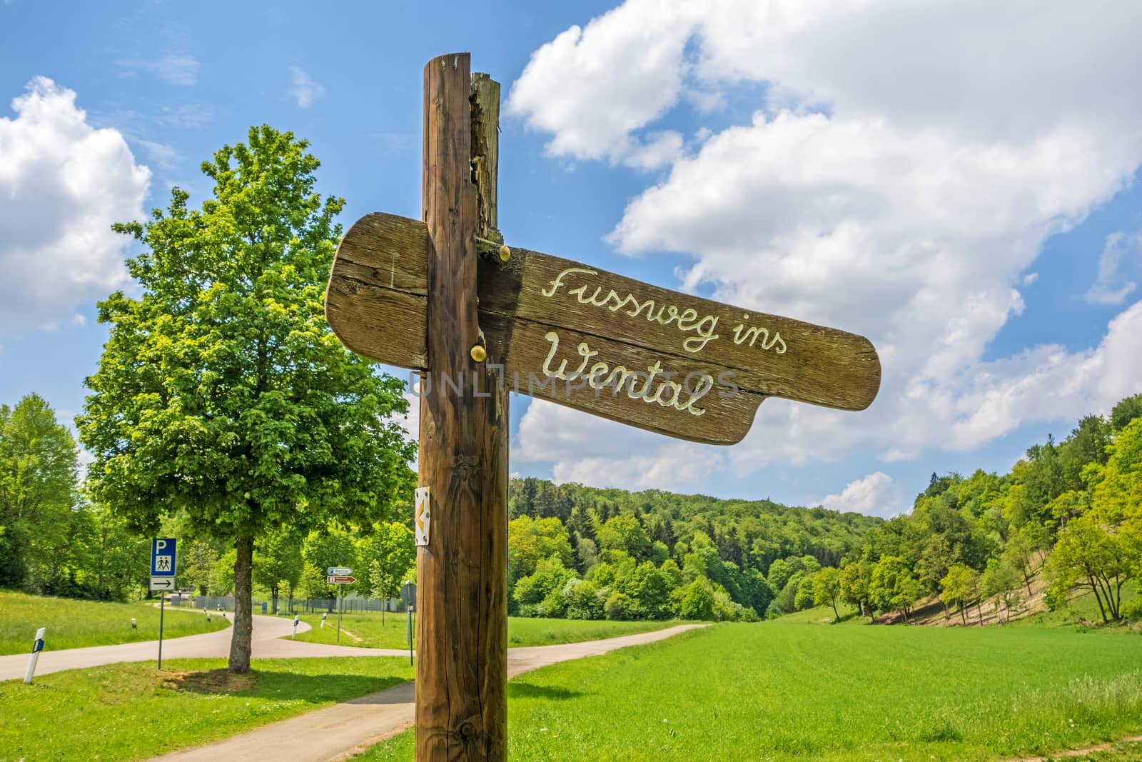 Wooden signpost labeld with footpath to the Wental valley (Fussweg ins Wental)