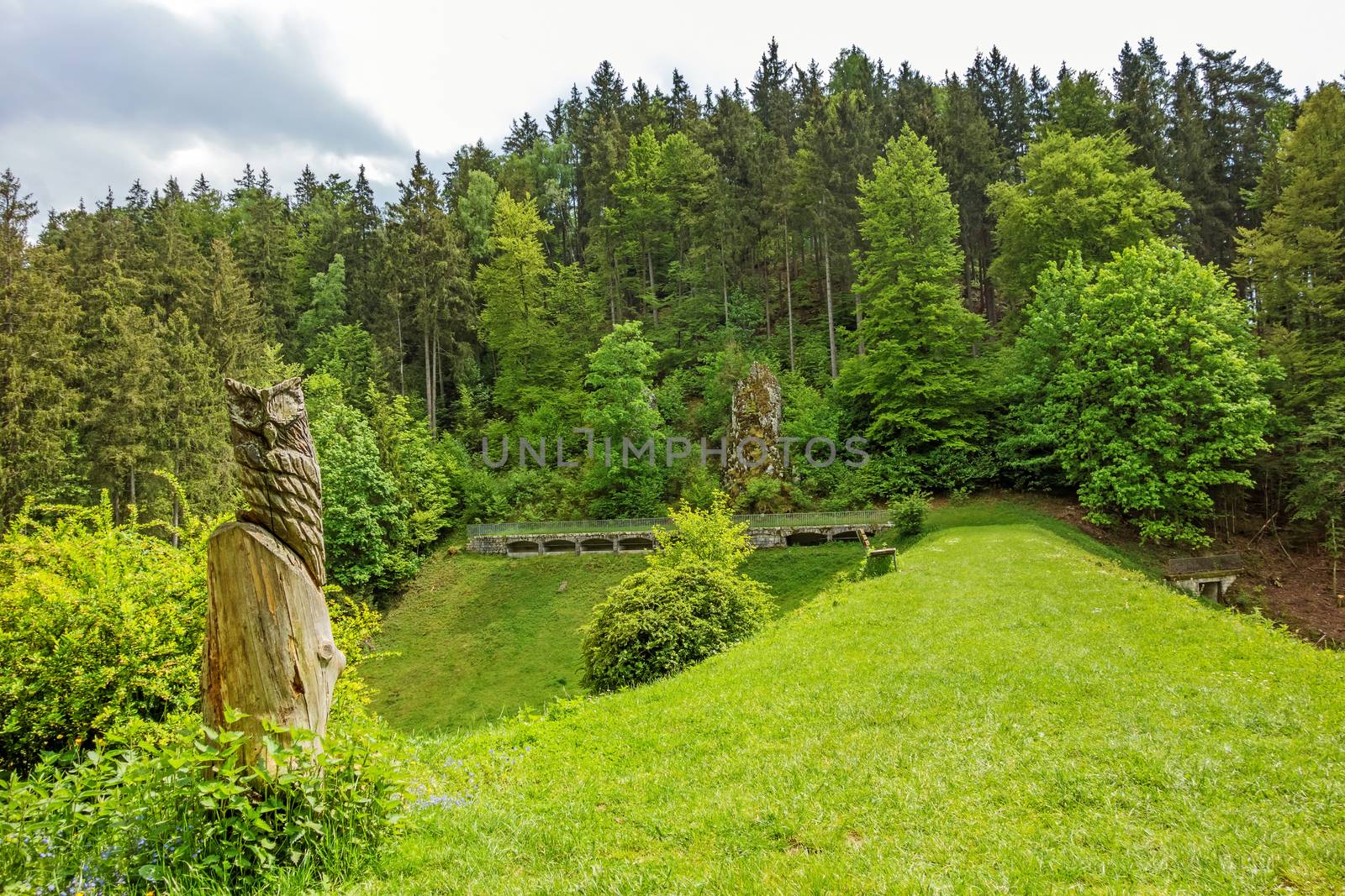 Wental valley reservoir dam - forest / trees in background, carved owl in foreground - Swabian Alps (Schwaebische Alb)