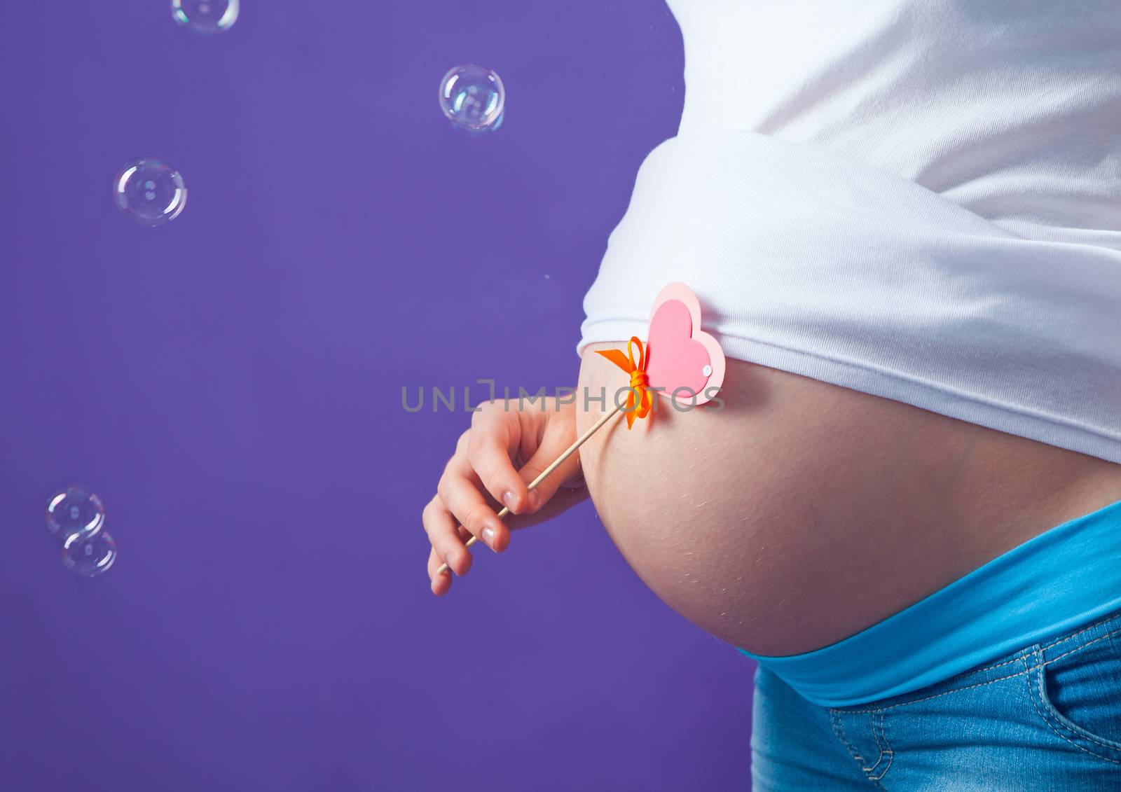 caucasian pregnant woman stress anxious with butterfly in the stomach isolated studio on gray background.
