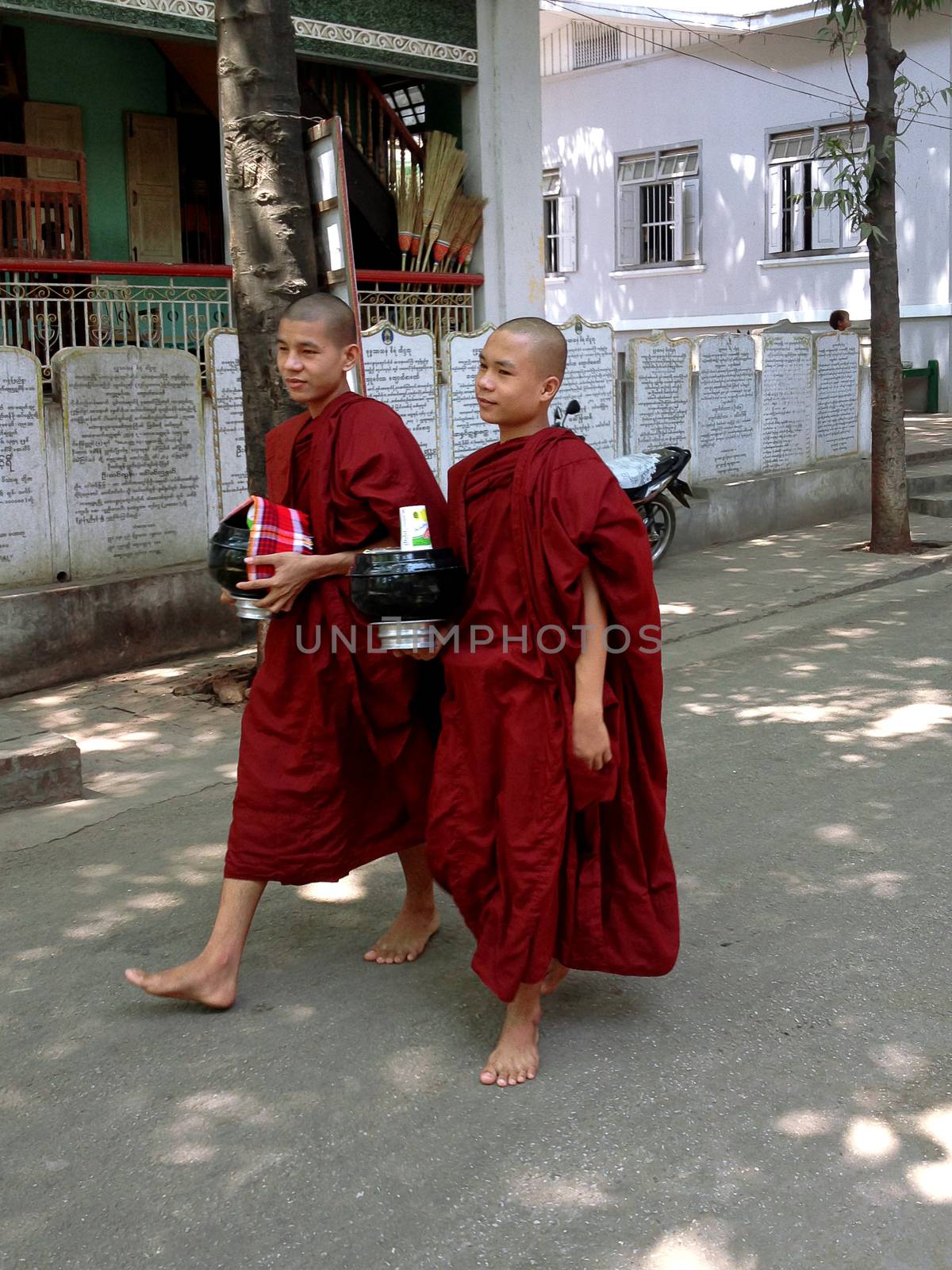 AMARAPURA, MYANMAR, APRIL 21, 2013 : young buddhist novices walk in Mahagandayon monastery near Mandalay, Myanmar (Burma)