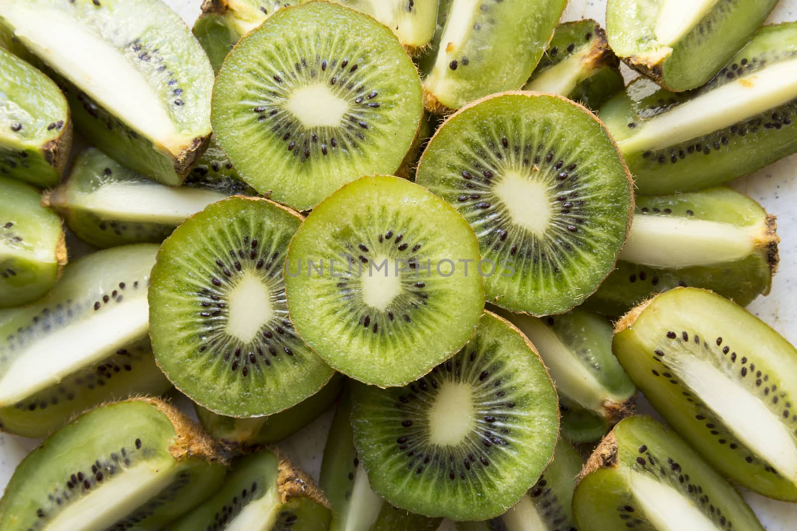 Fresh organic Kiwi Fruit Slices arranged showing the pips & structure